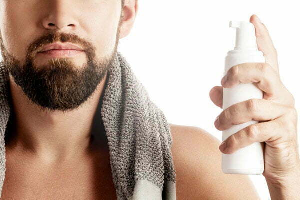 hand-holds-foam-pump-facial-cleanser-bottle hand-holds-foam-pump-facial-cleanser-bottle
