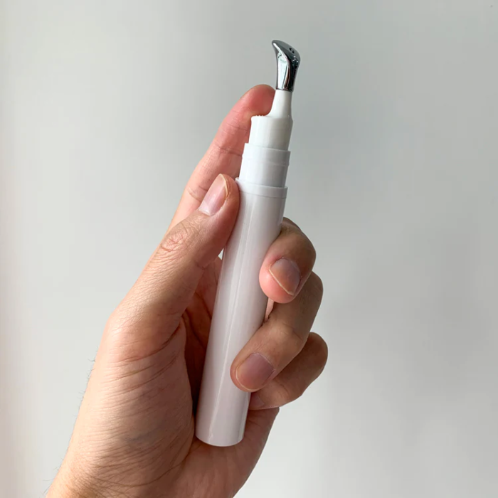 white cosmetic eye serum cream bottle with metal head