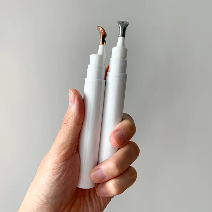 white cosmetic eye serum cream bottle with metal head